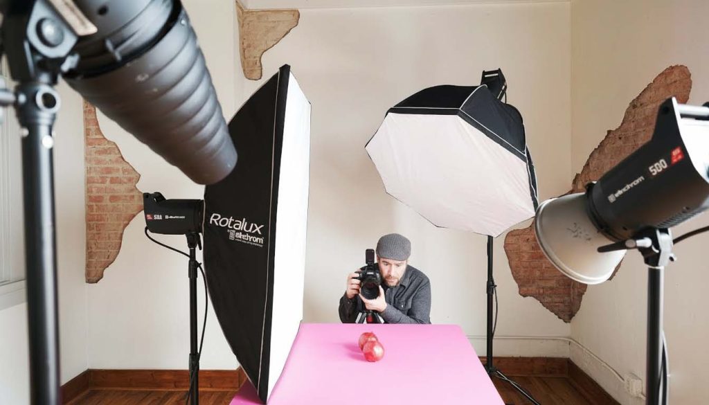 Studio setup showing a light source and reflector used for professional product photography