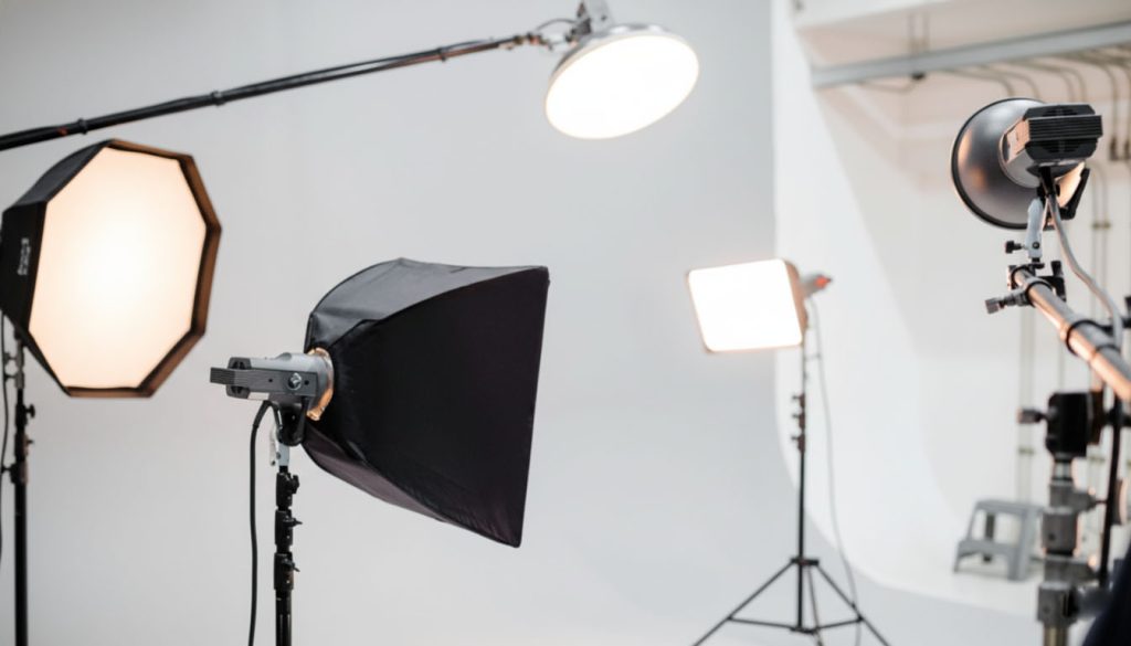 Photography gear collection including camera, lenses, lighting, and professional accessories